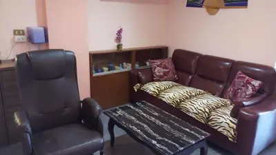 a living room with a leather couch and a chair at Condopatong in Patong Beach
