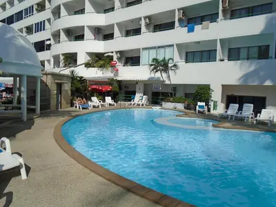 a large swimming pool in front of a building at Condopatong in Patong Beach
