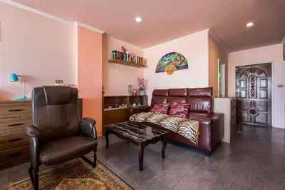 a living room with a couch and a chair at Condopatong in Patong Beach