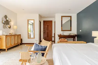 a bedroom with a large bed and a table at Luxury 4BR Villa with Pool & Ocean Views on Patong in Patong Beach