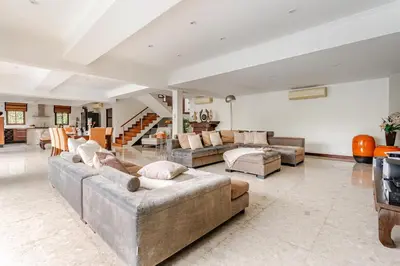 a large living room with couches and a staircase at Luxury 4BR Villa with Pool & Ocean Views on Patong in Patong Beach