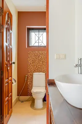 a bathroom with a toilet and a sink at Luxury 4BR Villa with Pool & Ocean Views on Patong in Patong Beach