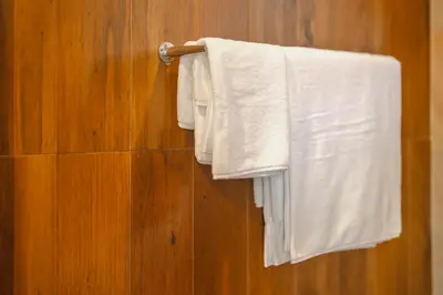 a group of white towels hanging on a towel rack at 3 Bedrooms villa walking distance to Rawai beach in Rawai Beach
