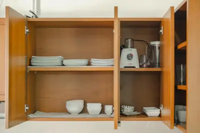 a cupboard with plates and dishes in it at 3 Bedrooms villa walking distance to Rawai beach in Rawai Beach