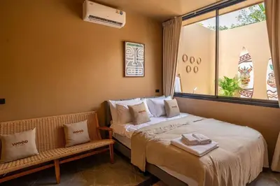 a hotel room with a bed and a window at The Wood Terrace in Ban Chin Tham Mai