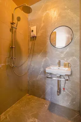 a bathroom with a sink and a mirror at The Wood Terrace in Ban Chin Tham Mai