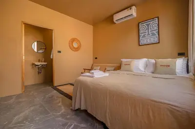 a bedroom with a large bed and a sink at The Wood Terrace in Ban Chin Tham Mai