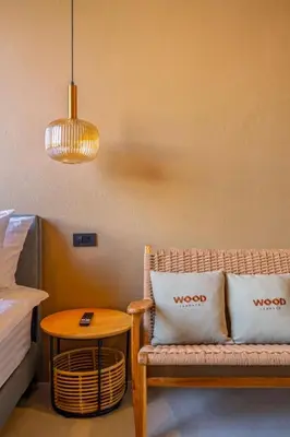 a room with a couch and a table next to a bed at The Wood Terrace in Ban Chin Tham Mai