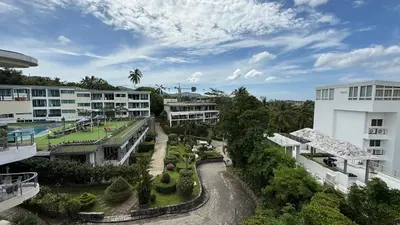 an aerial view of a resort with a tennis court at Karon Butterfly Seaview Home in Phuket Town