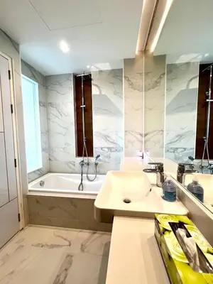 a bathroom with a sink and a bath tub at Beachfront Bliss at Naiyang Phuket by ALPHATEL in Phuket