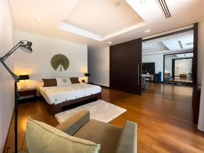 a bedroom with a bed and a couch in a room at Charming 3-bdr apartment with pool in Bang Tao Beach