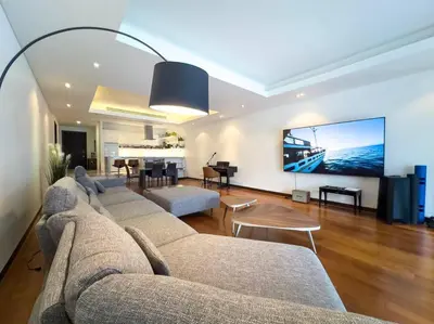 a living room with a couch and a tv at Charming 3-bdr apartment with pool in Bang Tao Beach
