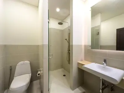 a bathroom with a toilet and a sink and a shower at Charming 3-bdr apartment with pool in Bang Tao Beach