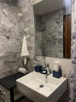 a bathroom with a white sink and a mirror at Sunset Room Phuket in Ban Mai Salae