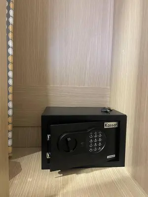 a microwave sitting in a corner of a room at Sunset Room Phuket in Ban Mai Salae