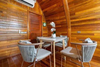 a dining room with a white table and chairs at Tropical Chalet-Style 2BR Villa with Pool Pasak Paradise 2, Bangtao in Bang Tao Beach
