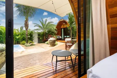 an open patio with a table and a stool on a deck at Tropical Chalet-Style 2BR Villa with Pool Pasak Paradise 2, Bangtao in Bang Tao Beach