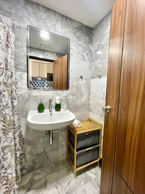a bathroom with a sink and a mirror at Cozy Room Phuket in Ban Mai Salae