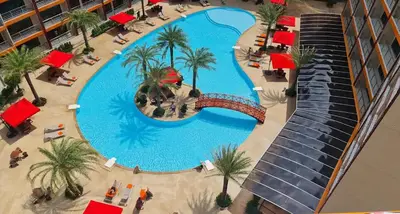 an overhead view of a large swimming pool with palm trees at Cozy Room Phuket in Ban Mai Salae