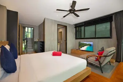 a bedroom with a white bed and a ceiling fan at Private & Modern 4BR Pool Villa Otero, 3 Levels of Comfort with Greenery Views, Kamala in Kamala Beach