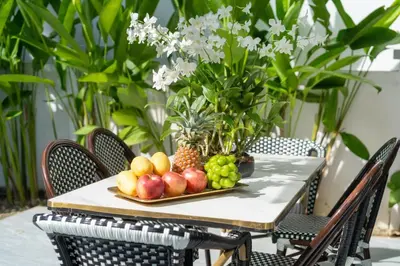 a table with a plate of fruit on it at Villa with swimming pool in Ravai 17 in Ban Saiyuan (1)