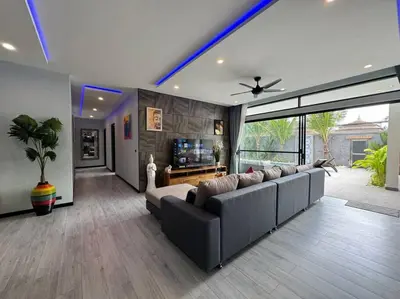a large living room with a couch and a television at Luciana Villa by G Estate Phuket in Rawai Beach