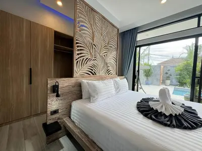 a bedroom with a large bed with a large window at Luciana Villa by G Estate Phuket in Rawai Beach