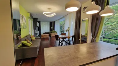 a living room with a couch and a table at Просторная квартира с одной спальней in Kamala Beach