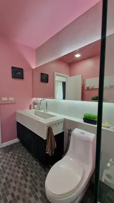 a pink bathroom with a toilet and a sink at Просторная квартира с одной спальней in Kamala Beach