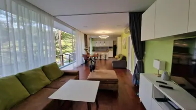 a living room with a couch and a table at Просторная квартира с одной спальней in Kamala Beach