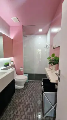 a pink bathroom with a toilet and a sink at Просторная квартира с одной спальней in Kamala Beach