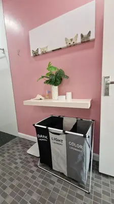 a trash can in a room with a pink wall at Просторная квартира с одной спальней in Kamala Beach