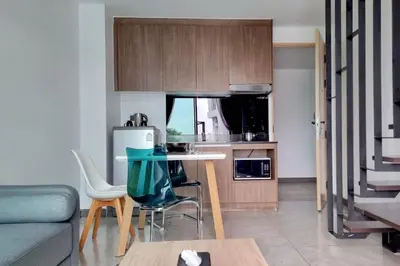 a small kitchen with a table and chairs in a room at Perfect Holiday Spot - Pool View Duplex in Tropical Naiharn! UTL A310 in Rawai Beach