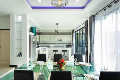 a dining room with a glass table and chairs at Kathu V pool villa 171 in Kathu