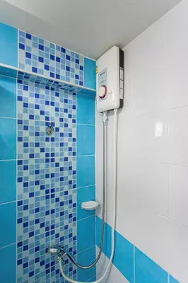 a shower in a bathroom with blue tiles at Kathu V pool villa 171 in Kathu