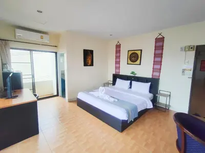 a bedroom with a large bed and a television at L&K2023 Residence in Patong Beach