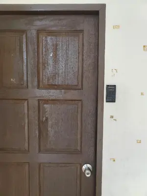a wooden door in a room next to a wall at L&K2023 Residence in Patong Beach