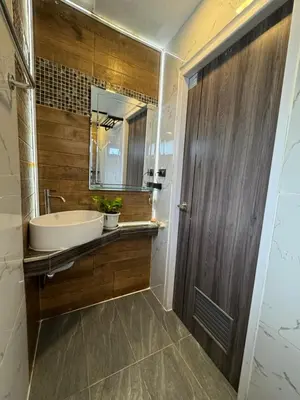 a bathroom with a tub and a sink and a mirror at Rinda House Patong 31-1 in Patong Beach