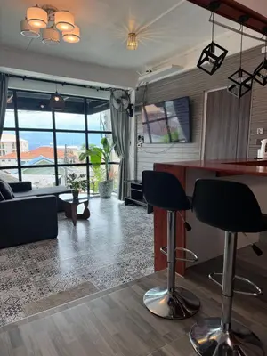a living room with a bar and a couch at Rinda House Patong 31-1 in Patong Beach