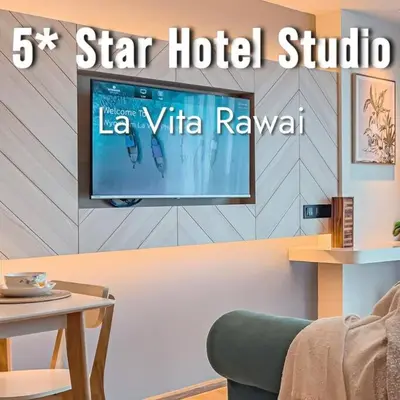 a living room with a tv on a wall at 5 Star La Vita Studio Rawai 702 in Phuket Town