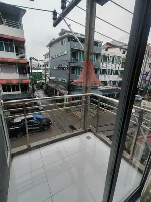 a view of a city street from a window at Madam Inn Patong in Patong Beach