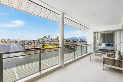 a large balcony with a view of the water at Beachfront 3BR Penthouse with Private Rooftop Pool - Laguna, BangTao in Phuket Town
