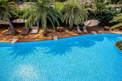 an overhead view of a swimming pool with palm trees at Tropical Bliss, Relax & Enjoy at 1BR Apartment MBC near Mai Khao Beach! in Mai Khao Beach