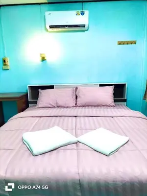a large bed with two white pillows on it at Alanta aonang resort in Ban Khlong Haeng