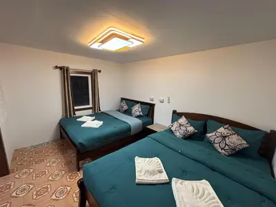 a room with two beds and a couch in it at Alanta aonang resort in Ban Khlong Haeng