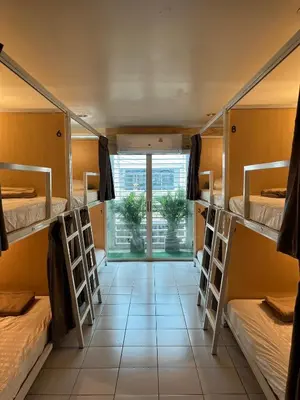 a room with four bunk beds and a window at Mawa Anle Hostel in Patong Beach