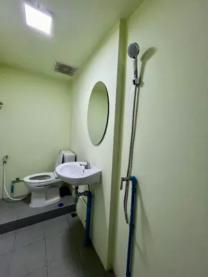 a bathroom with a toilet and a sink and a mirror at Mawa Anle Hostel in Patong Beach