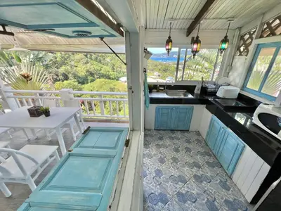 an rv kitchen with a table and a sink at Patong seaview 2bedrooms white house in Patong Beach