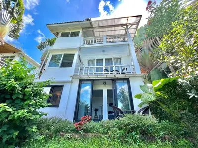 a white house with a balcony on top of it at Patong seaview 2bedrooms white house in Patong Beach