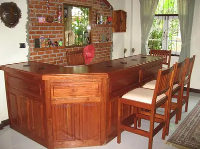 a large wooden desk in a room with chairs at Luxury Pool Villa by Golf Courses & Elephant Sanctuary in Kathu